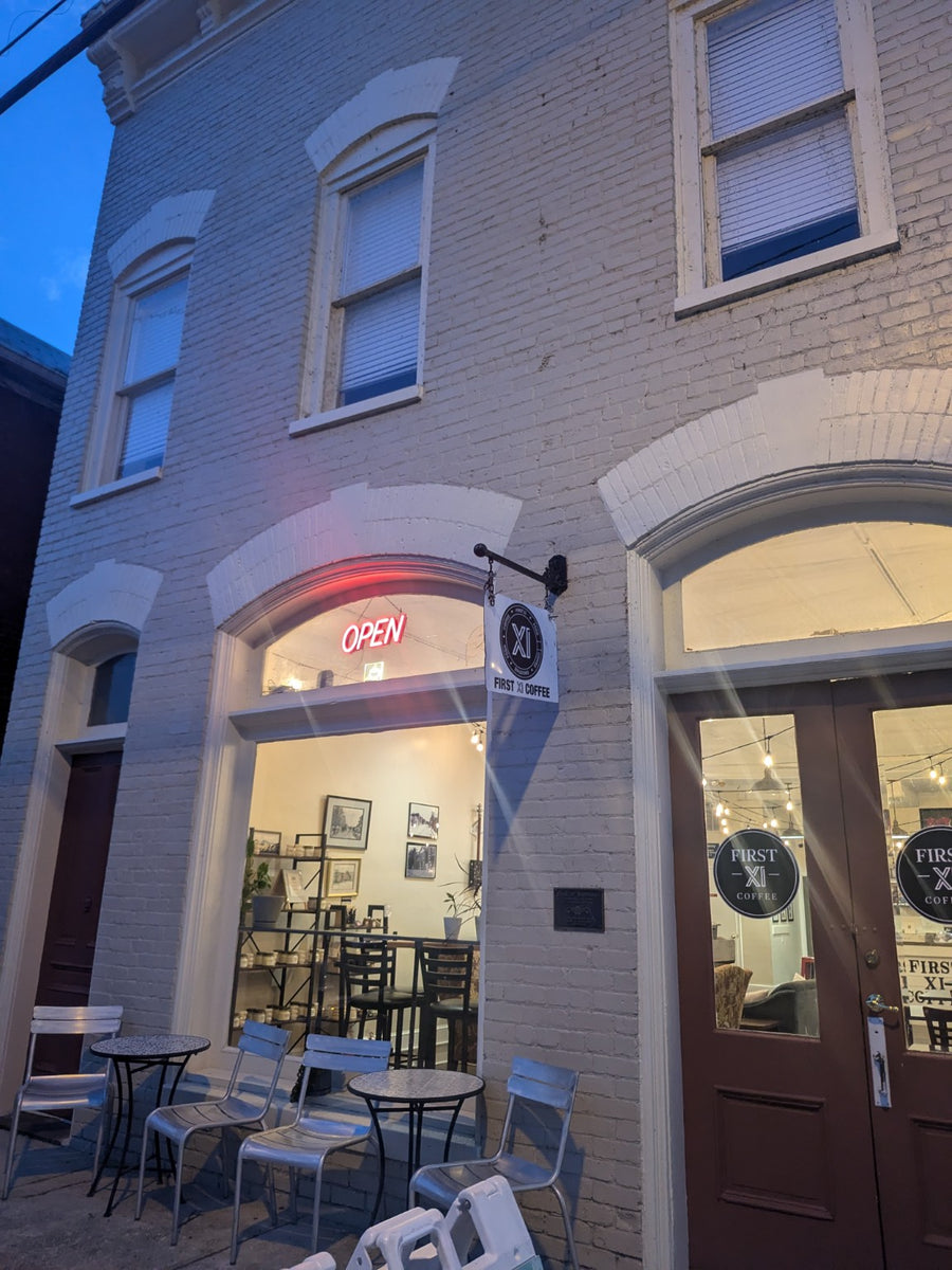 First XI Coffee storefront in the evening
